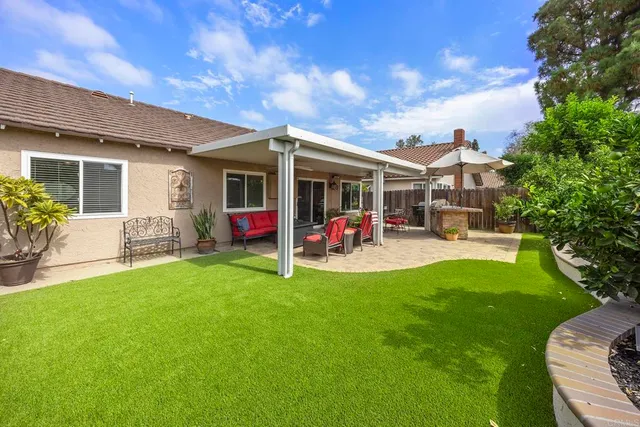 a view of a house with backyard porch and furniture