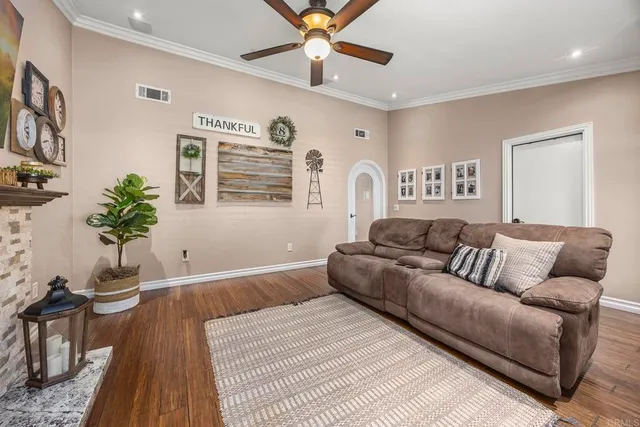 a living room with furniture and wooden floor