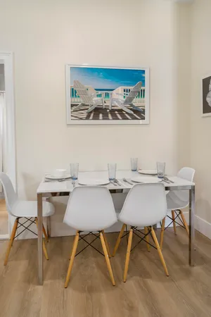 a view of a dining room with furniture and chandelier