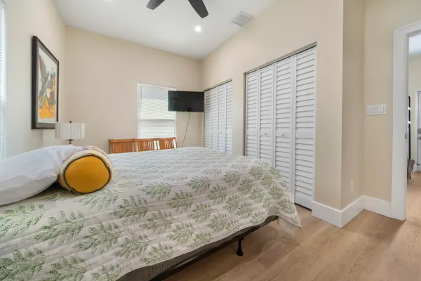 a bedroom with a bed and a chandelier