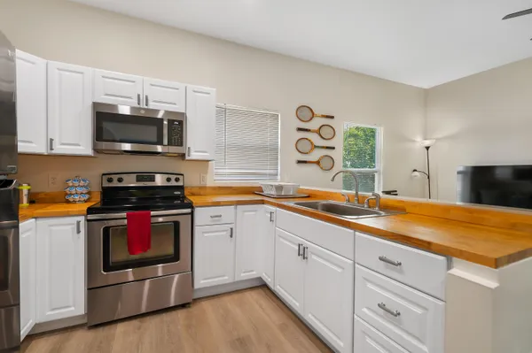 a kitchen with stainless steel appliances granite countertop a stove and a sink