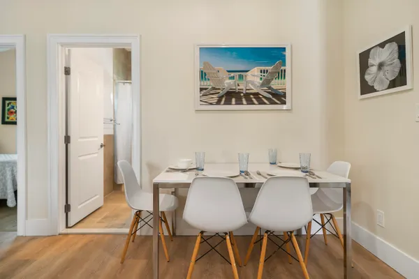 a view of a dining room with furniture and wooden floor