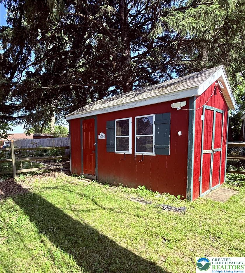 1275 Macada Road Bethlehem, PA 18017 - Photo 78 of 87 A vibrant red shed with green trim offers practical outdoor storage.