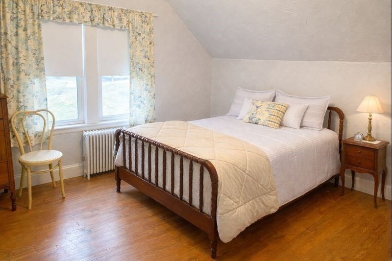 260 Elm Street Walpole, MA 02081 - Photo 19 of 32 a bedroom with a bed and a chair with the wooden floor