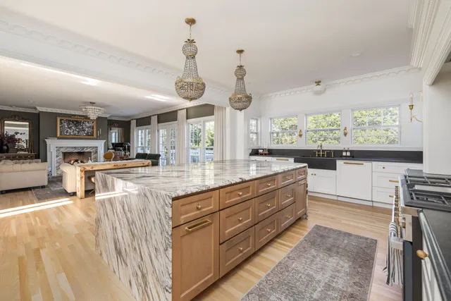 a kitchen with stainless steel appliances granite countertop a stove and a refrigerator