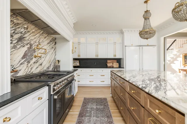 a large kitchen with a sink and cabinets