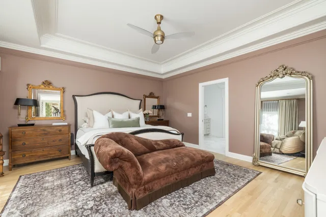 a bedroom with a bed a mirror and lamp