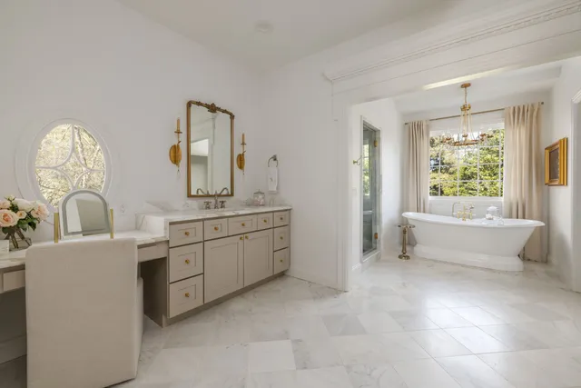 a bathroom with sink bathtub and double vanity