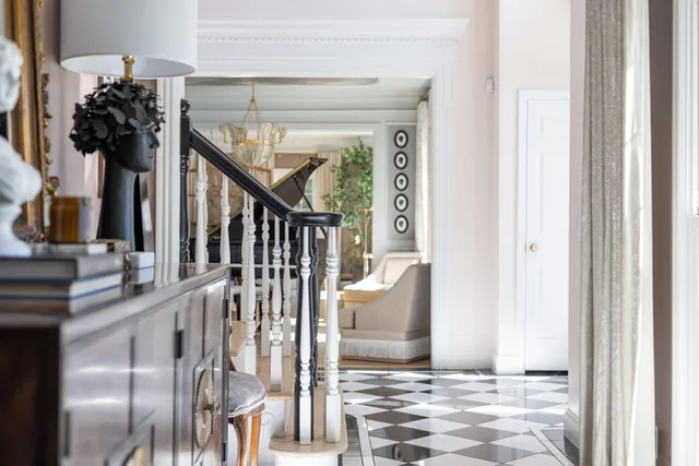 a bedroom with a bed and large windows