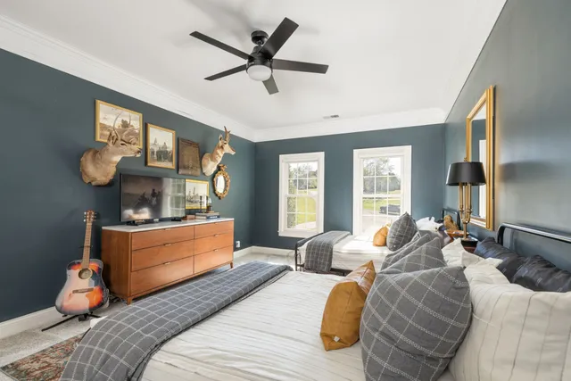 a sink with a painting on the wall and a potted plant