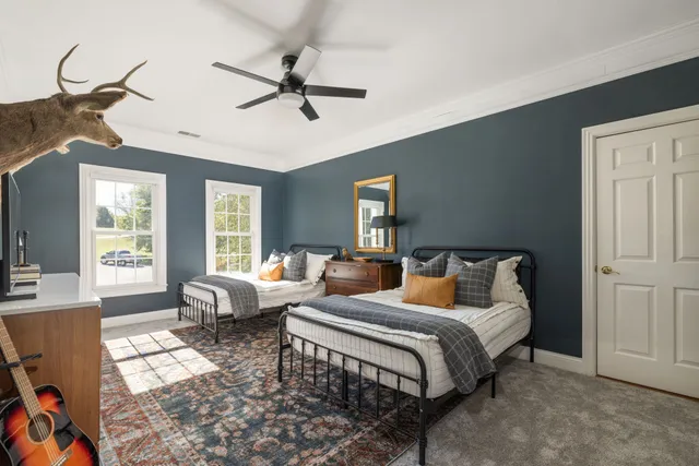 a bedroom with two beds and a window