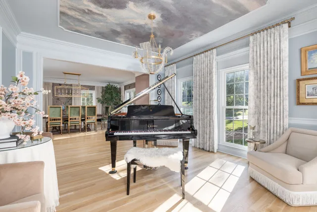 a living room with furniture and a chandelier
