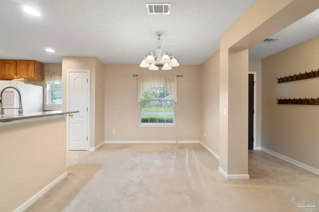 a view of a kitchen from the hallway