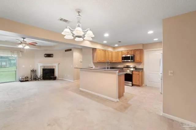 a view of a kitchen with a sink and a fireplace