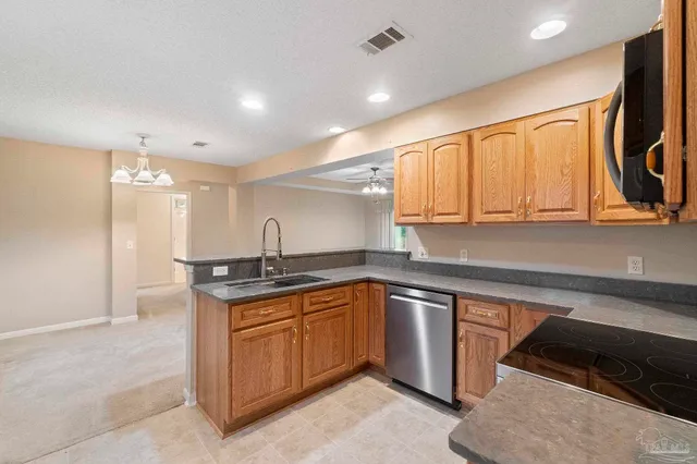 a kitchen with a sink stove and cabinets