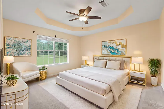 a bedroom with a bed a couch and a large window