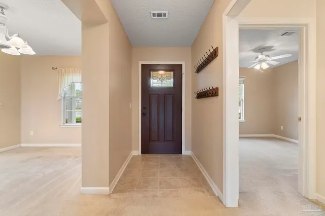 a view of a hallway with wooden floor and a living room