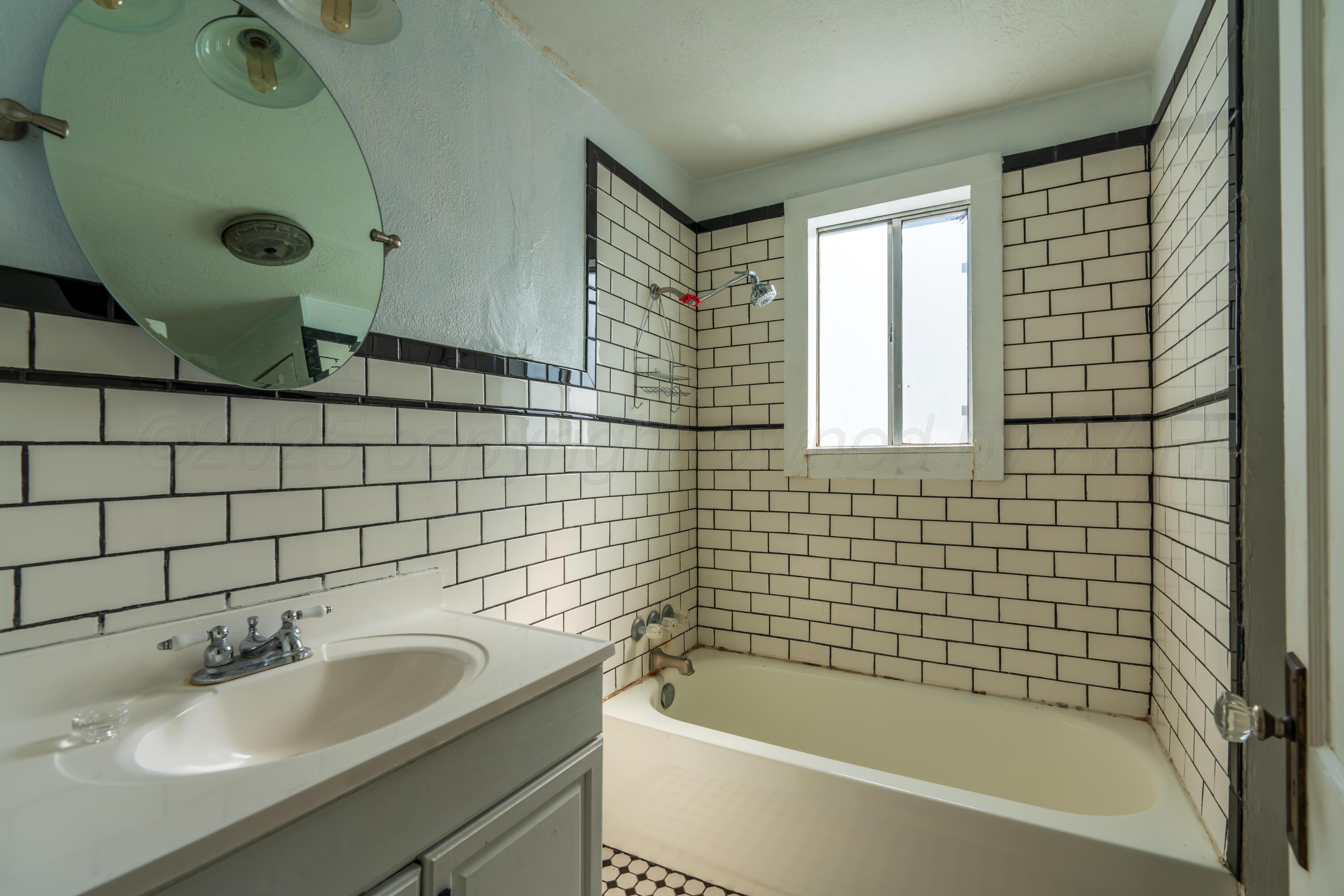1220 Southwest 12th Avenue Amarillo, TX 79102 - Photo 12 of 25 a bathroom with a sink and bathtub