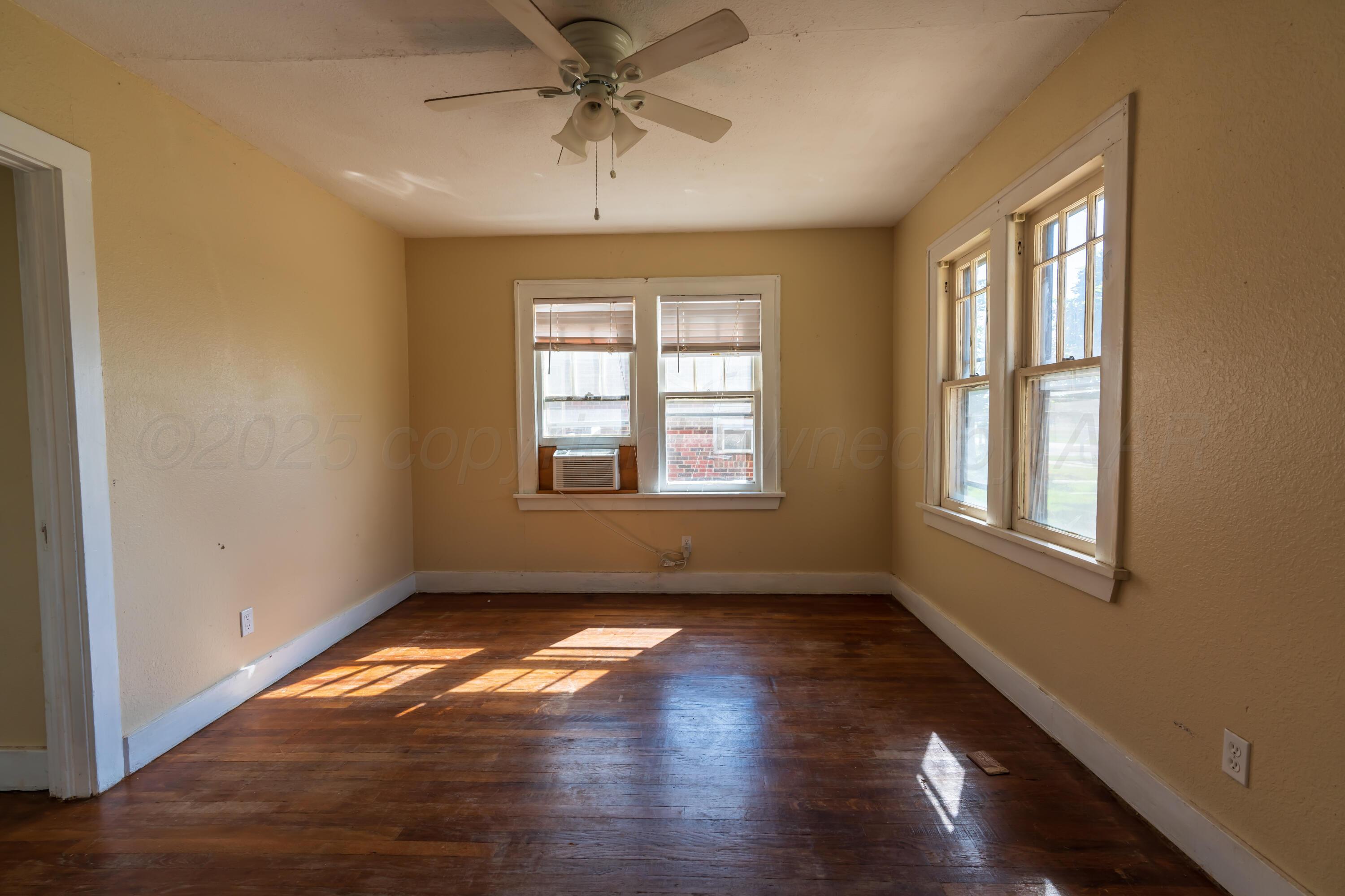 1220 Southwest 12th Avenue Amarillo, TX 79102 - Photo 13 of 25 a view of empty room with wooden floor and fan