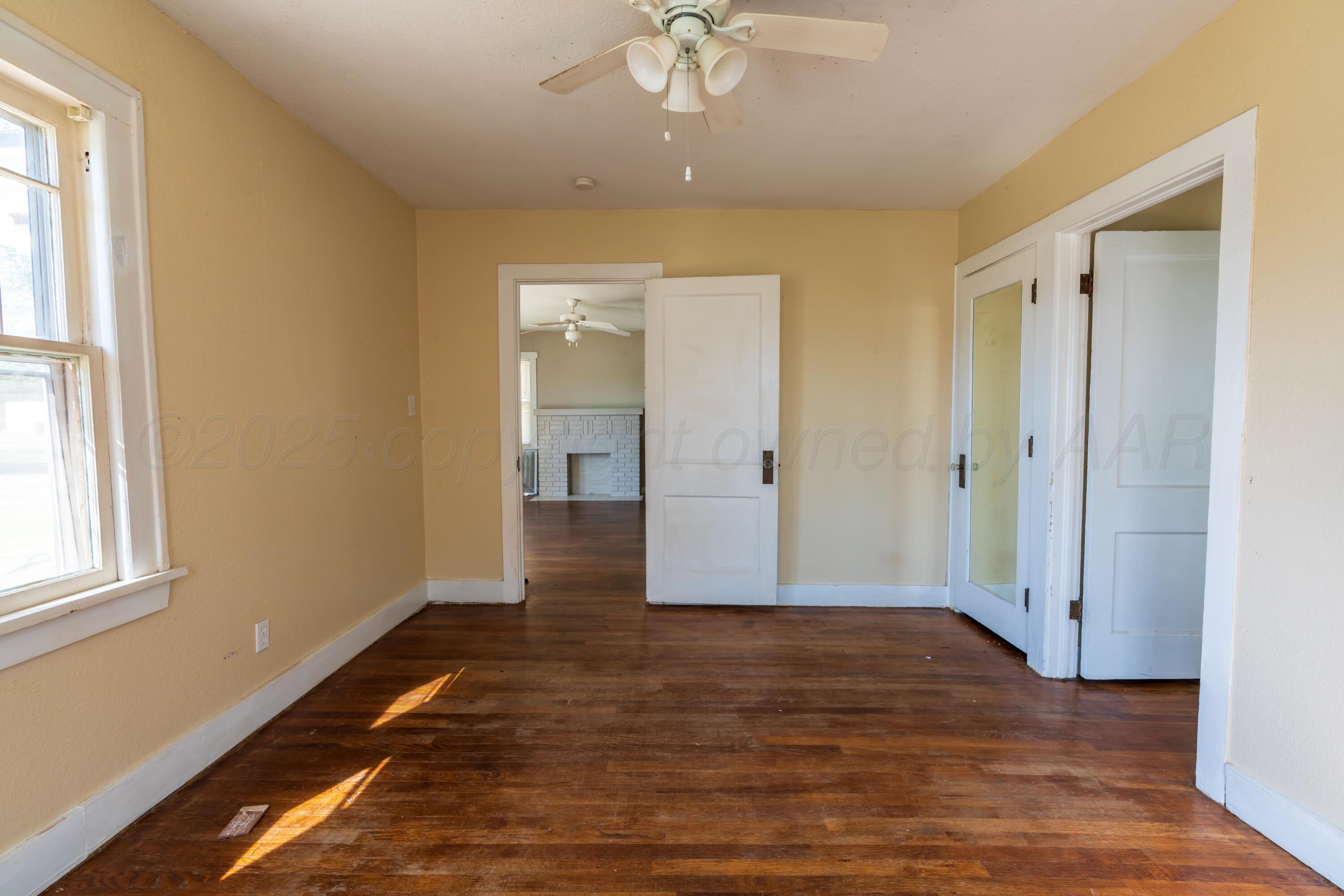 1220 Southwest 12th Avenue Amarillo, TX 79102 - Photo 14 of 25 wooden floor in an empty room with a window