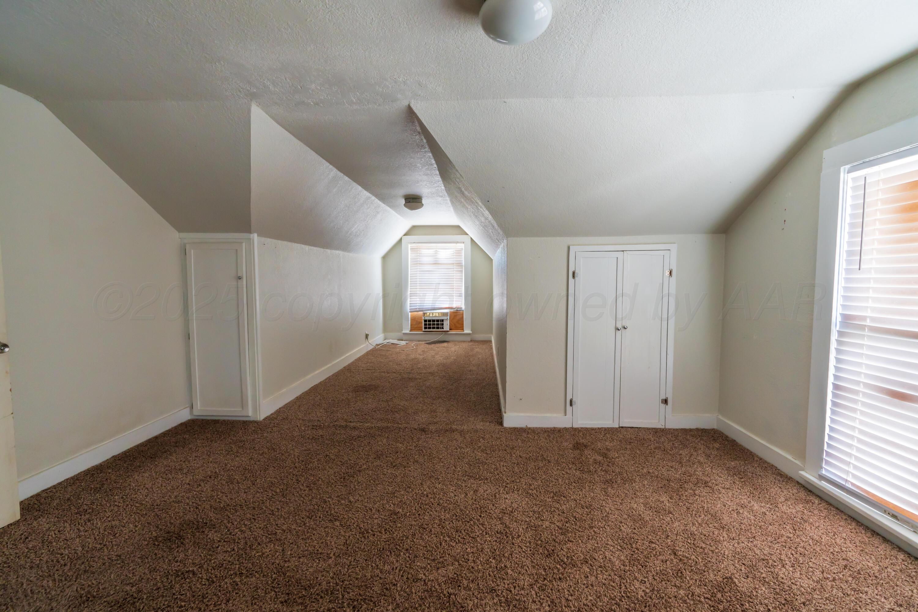 1220 Southwest 12th Avenue Amarillo, TX 79102 - Photo 19 of 25 a view of a big room with windows and chandelier fan
