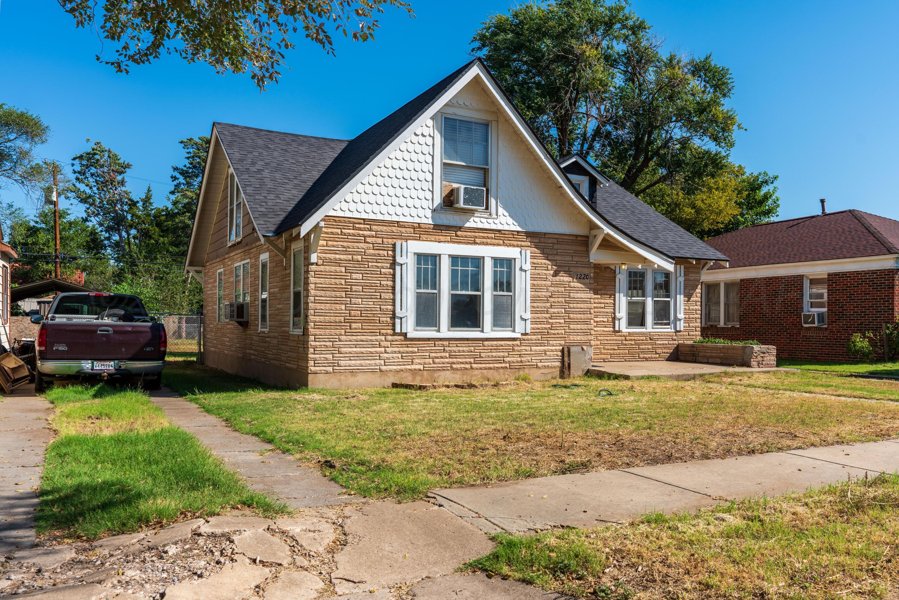1220 Southwest 12th Avenue Amarillo, TX 79102 - Photo 2 of 25 a front view of a house with a garden