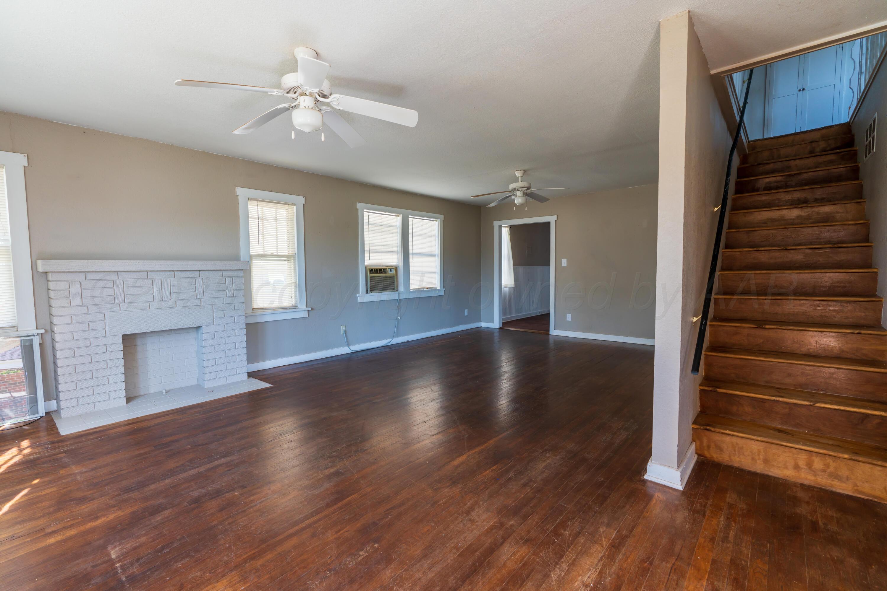 1220 Southwest 12th Avenue Amarillo, TX 79102 - Photo 5 of 25 a view of an empty room with wooden floor and a window
