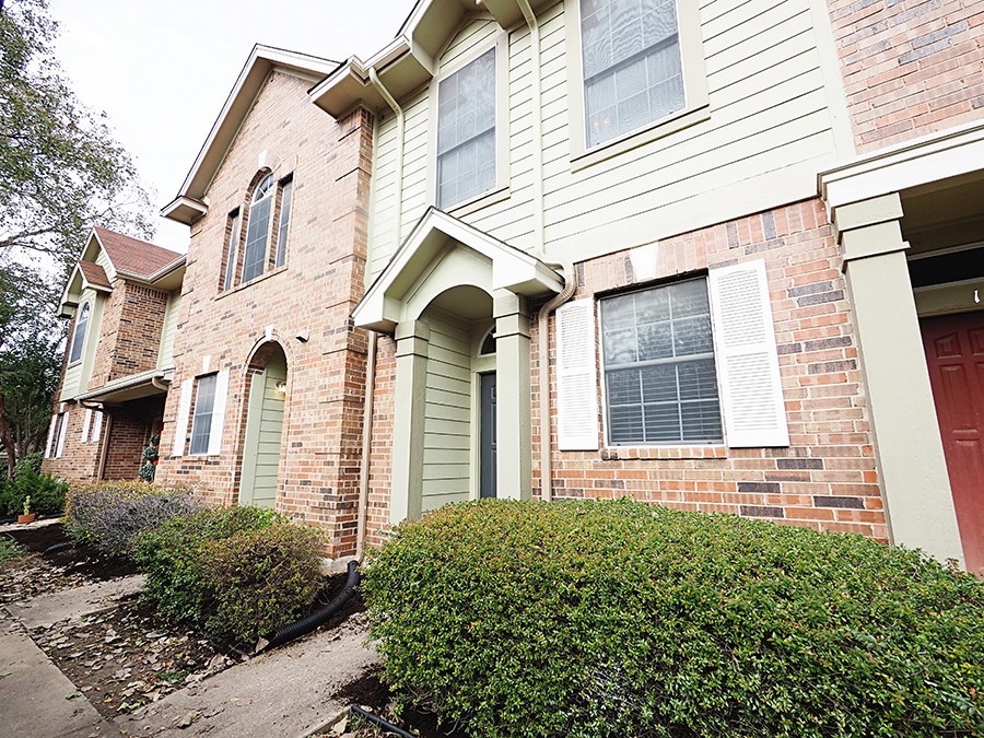 12401 Los Indios Trail, Unit 13 Austin, TX 78729 - Photo 1 of 27 a front view of a house with a yard