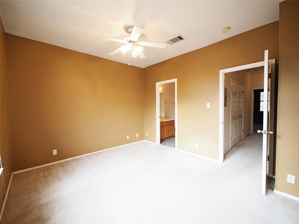 12401 Los Indios Trail, Unit 13 Austin, TX 78729 - Photo 12 of 27 a view of an empty room with a chandelier fan