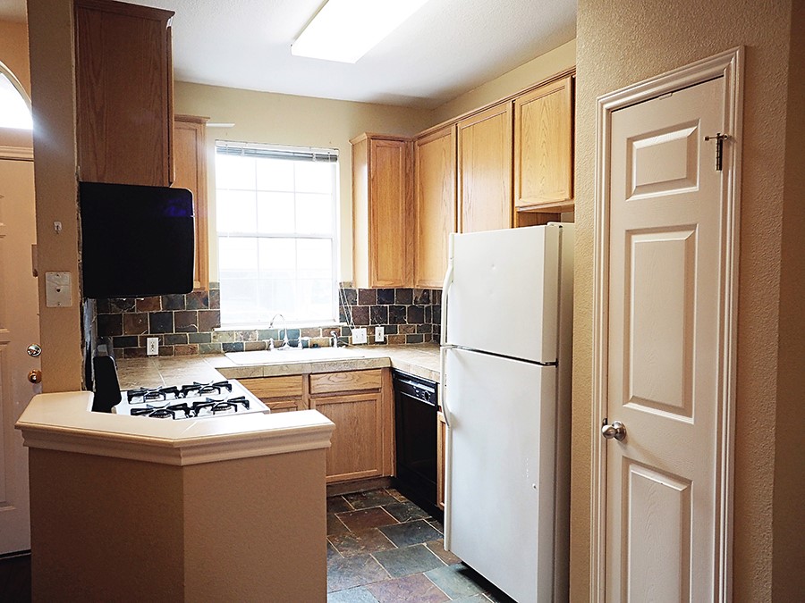 12401 Los Indios Trail, Unit 13 Austin, TX 78729 - Photo 17 of 27 a white refrigerator freezer sitting inside of a kitchen