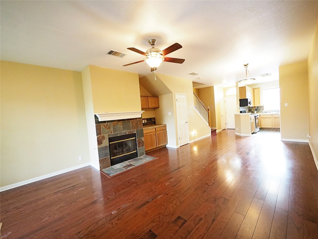 12401 Los Indios Trail, Unit 13 Austin, TX 78729 - Photo 19 of 27 a view of a kitchen with wooden floor and a ceiling fan