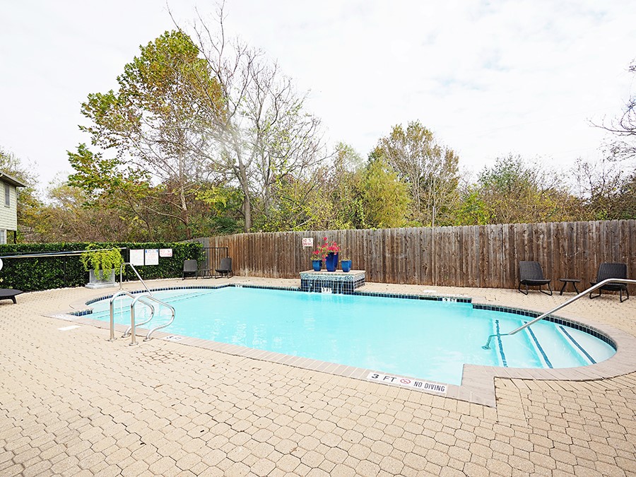 12401 Los Indios Trail, Unit 13 Austin, TX 78729 - Photo 23 of 27 a view of a swimming pool with a lounge chairs