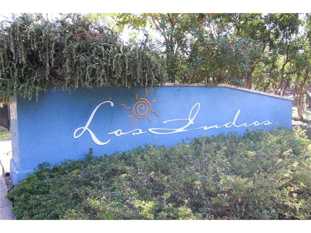 12401 Los Indios Trail, Unit 13 Austin, TX 78729 - Photo 26 of 27 a sign that is sitting on a brick wall