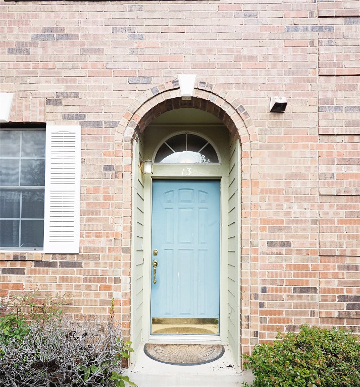 12401 Los Indios Trail, Unit 13 Austin, TX 78729 - Photo 27 of 27 a front view of a house with a door