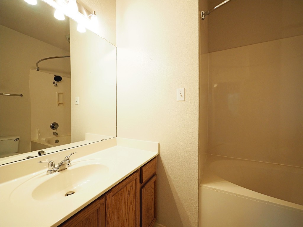 12401 Los Indios Trail, Unit 13 Austin, TX 78729 - Photo 8 of 27 a bathroom with a sink and a mirror