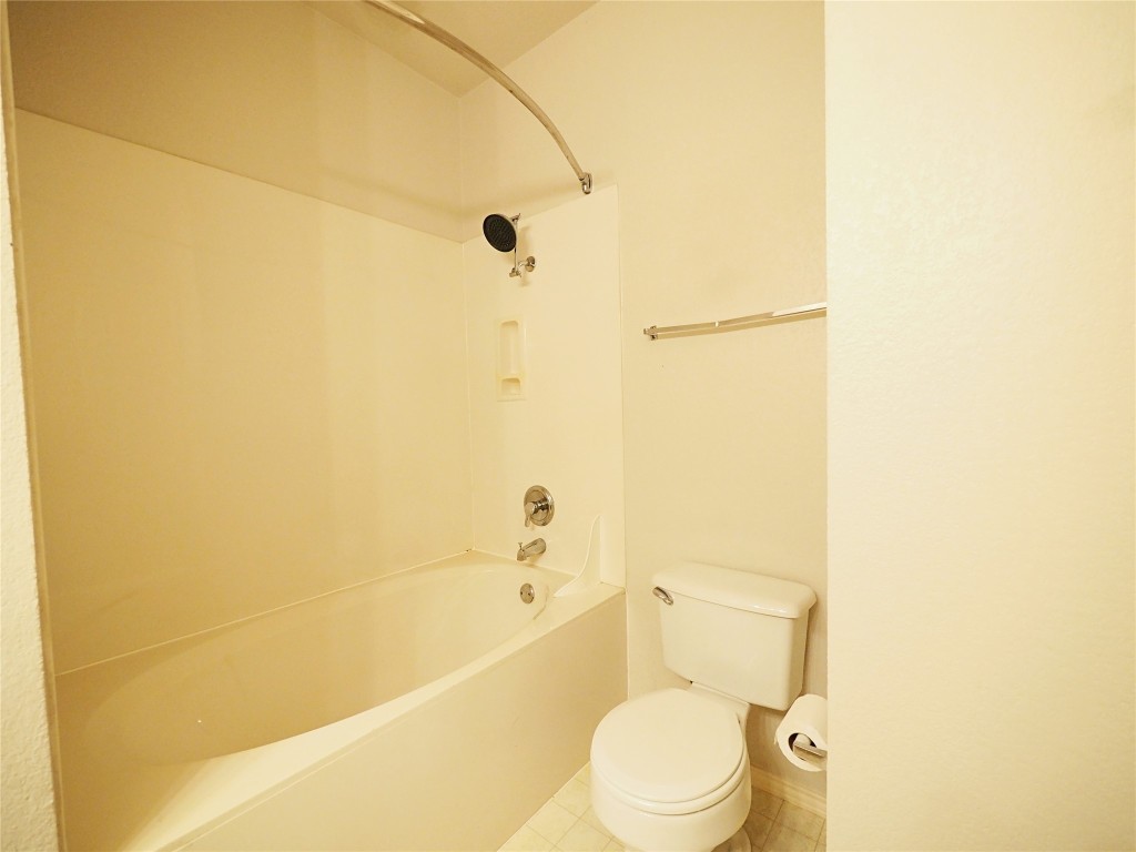 12401 Los Indios Trail, Unit 13 Austin, TX 78729 - Photo 9 of 27 a white toilet sitting next to a bath tub
