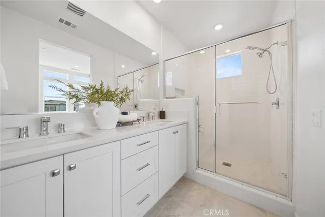 a bedroom with a large window and a bed