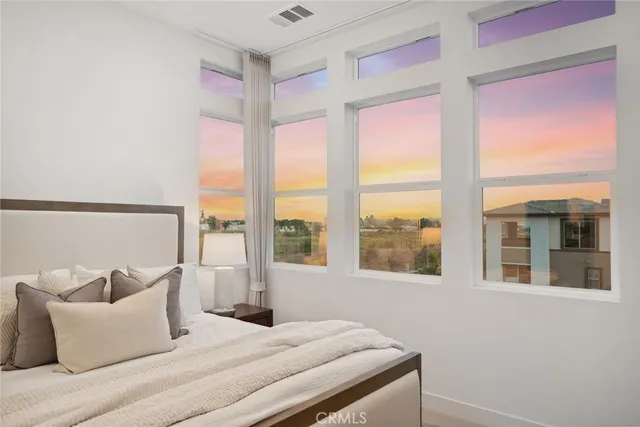 a view of a brick house with potted plants