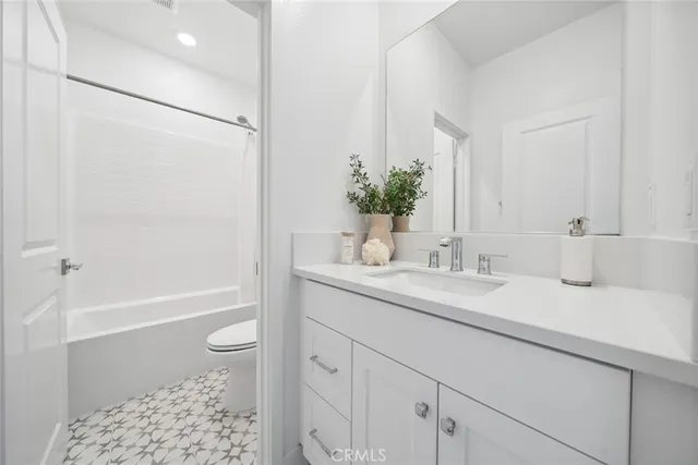 a white toilet sitting next to a bath tub