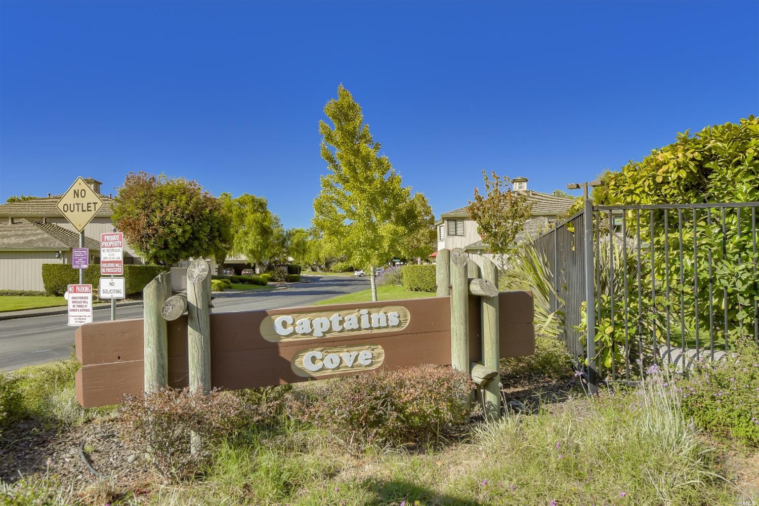 a sign board with a building in the background