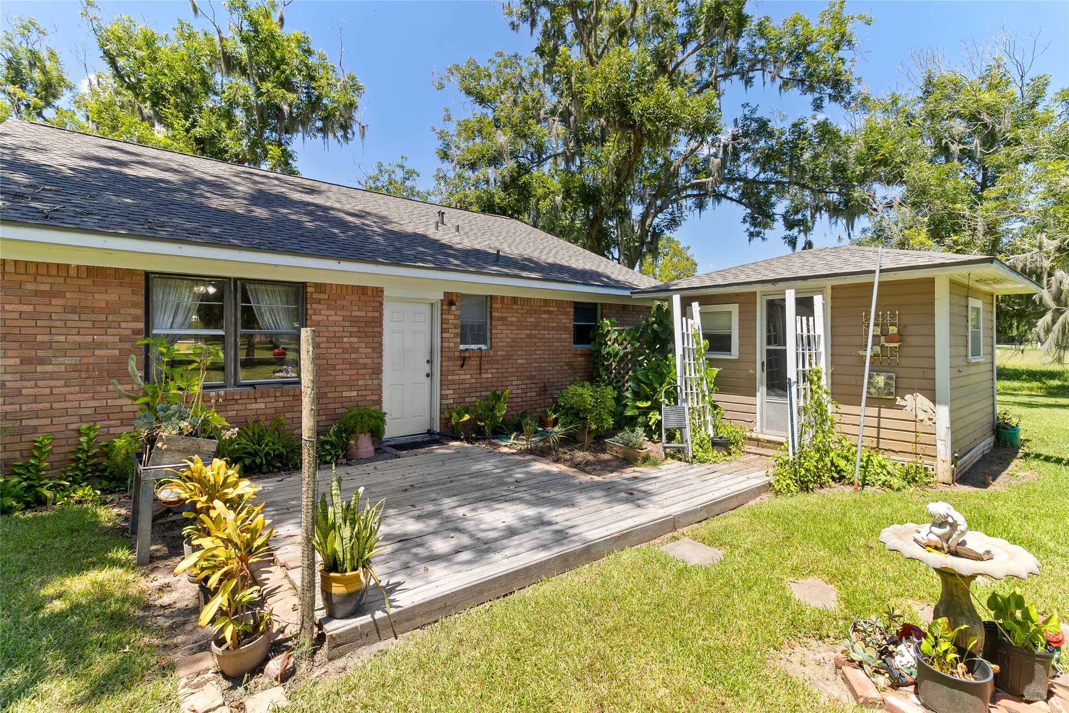1971 FM 522 Road Brazoria, TX 77422 - Photo 20 of 26 Back patio provides a dedicated outdoor space between the home and hobby shed (9x11), with convenient access to the oversized garage.