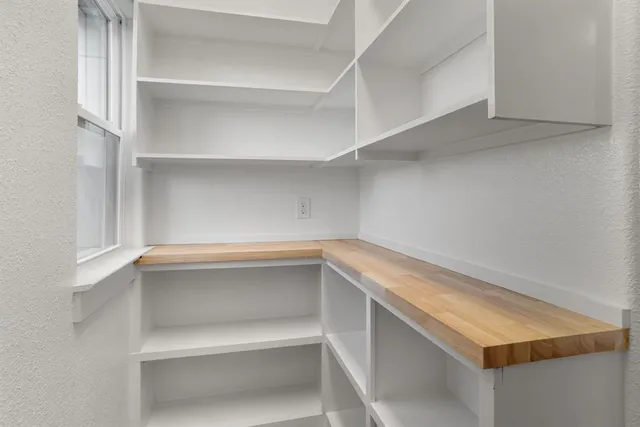 a view of a room with wooden floor and windows