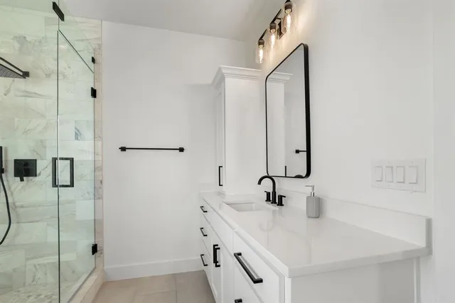 a bathroom with a double vanity sink mirror and