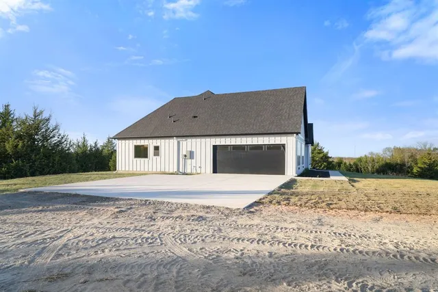a view of a field with trees in background