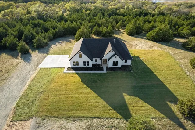 an aerial view of a house with outdoor space