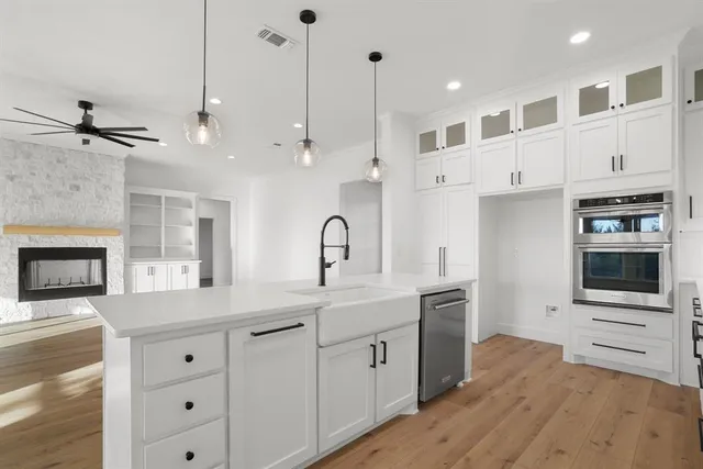 a kitchen with white cabinets and a stainless steel appliances