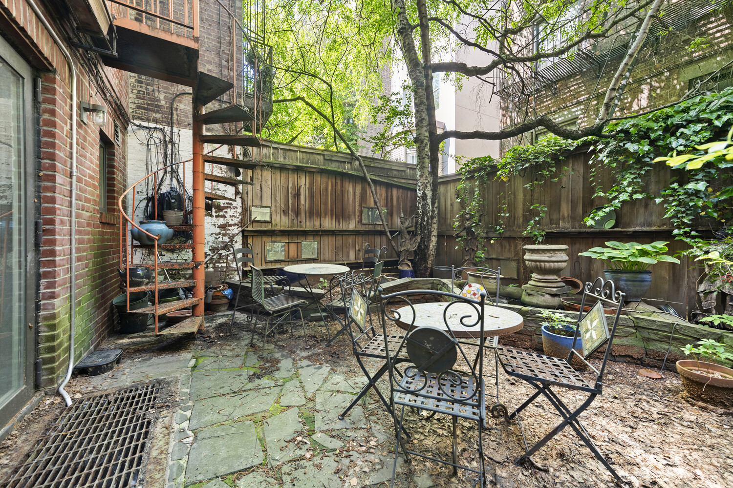 321 East 6th Street Manhattan, NY 10003 - Photo 9 of 13 a view of backyard with outdoor seating and trees