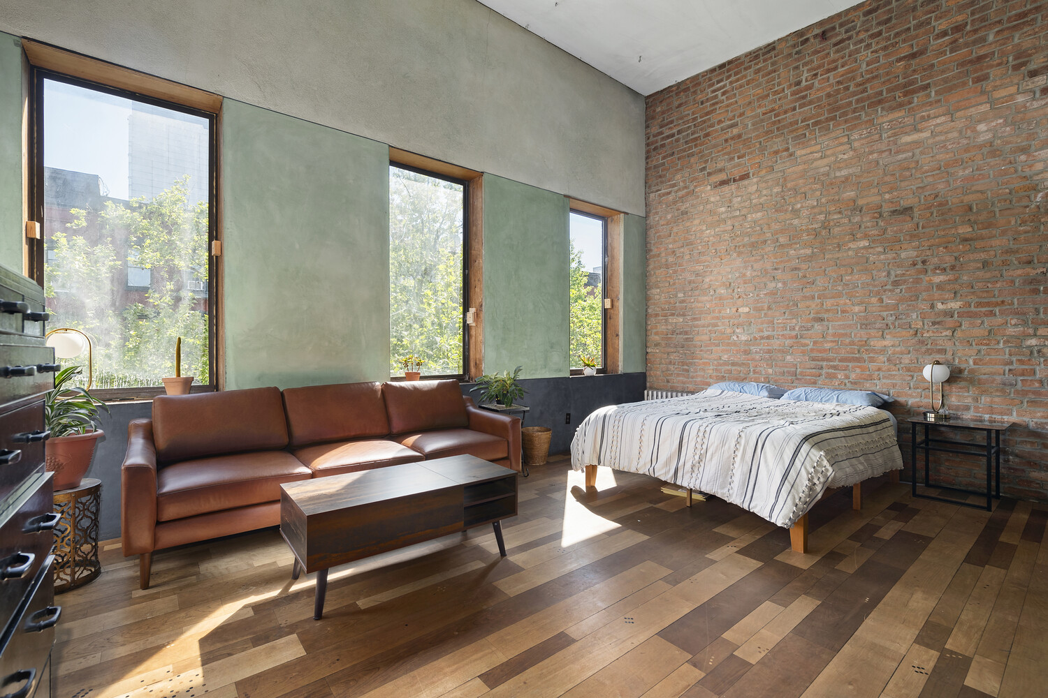 321 East 6th Street Manhattan, NY 10003 - Photo 5 of 13 a bedroom with a bed and wooden floor