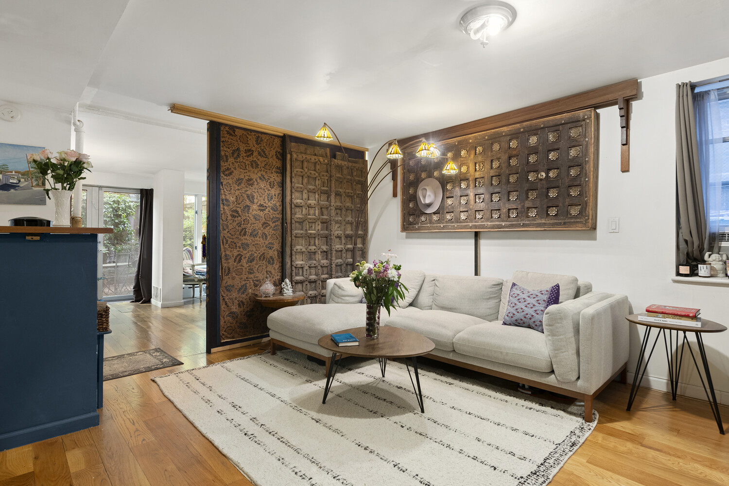 321 East 6th Street Manhattan, NY 10003 - Photo 6 of 13 a living room with furniture and a large window