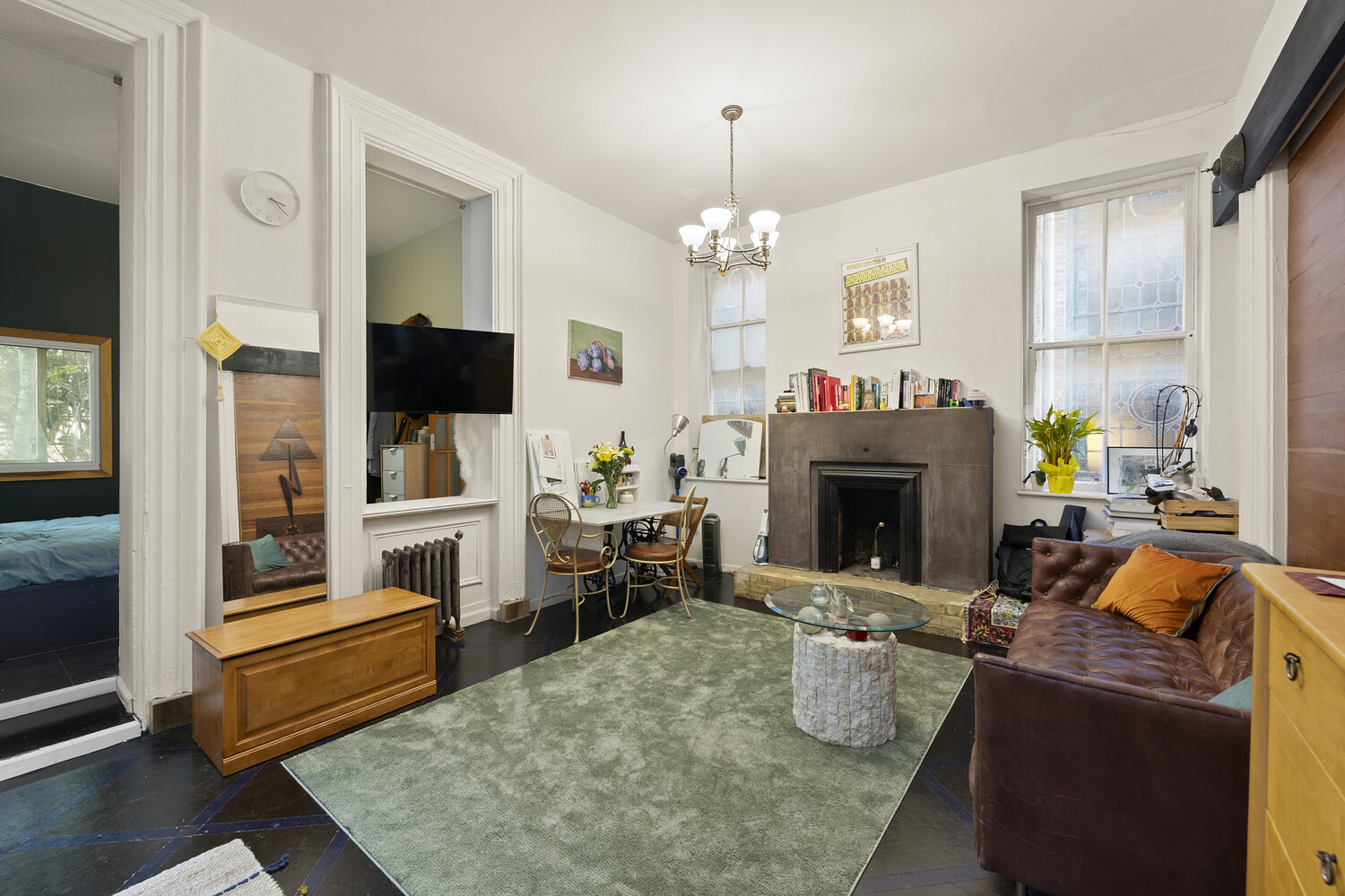 321 East 6th Street Manhattan, NY 10003 - Photo 7 of 13 a living room with furniture and a fireplace
